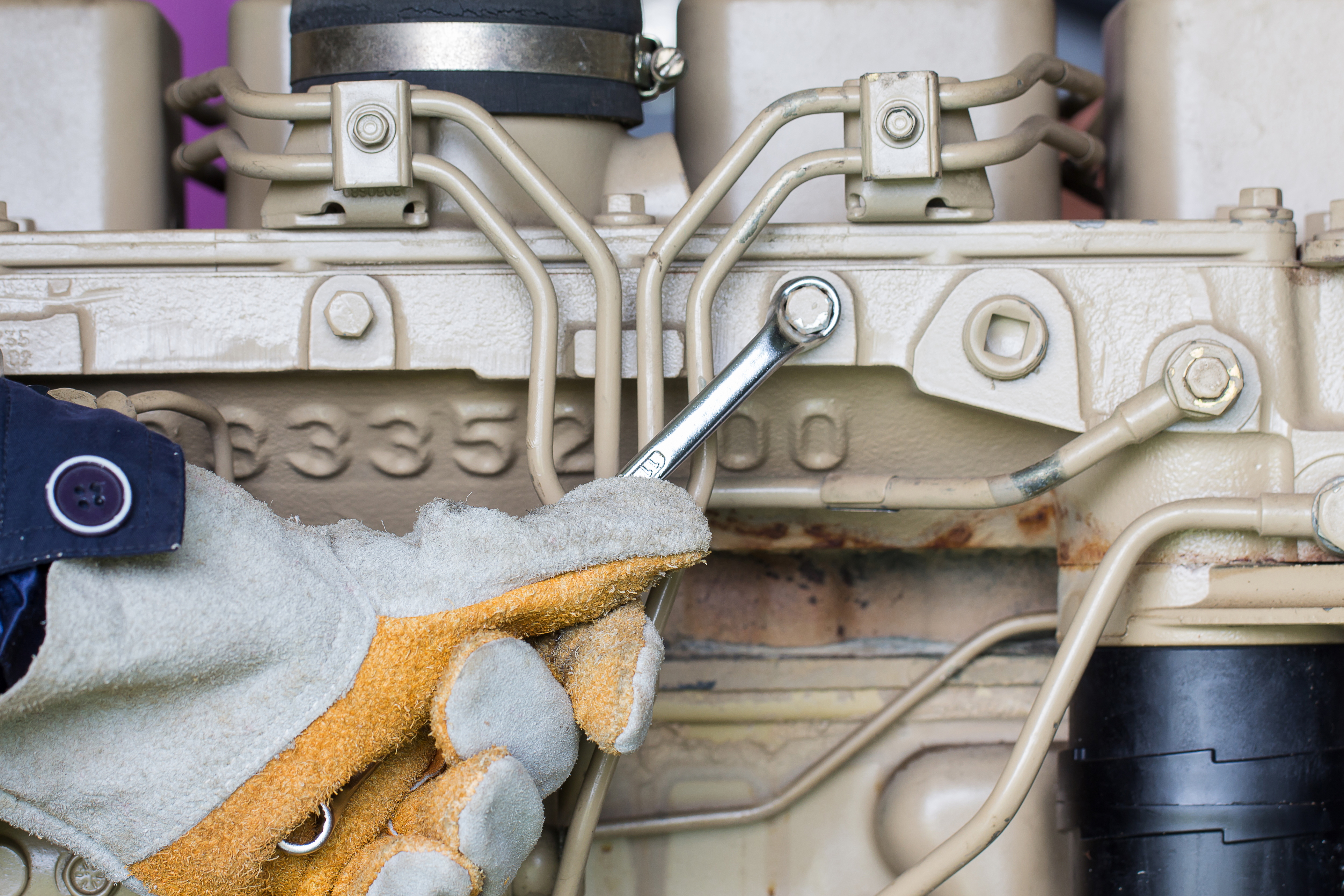 Closeup of an auto mechanic working on a Generator power engine - SandH